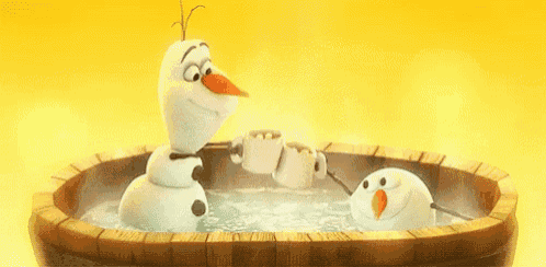olaf is taking a bath in a wooden tub with two cups of hot chocolate .