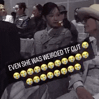 a group of people are sitting in a room with a sign that says `` even she was weirded tf out '' .