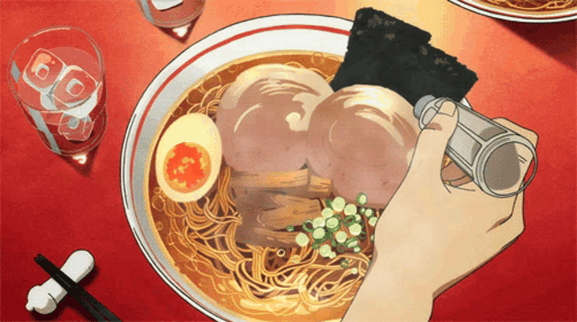a person is holding a salt shaker over a bowl of soup