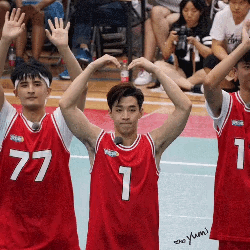 a group of basketball players wearing red jerseys with the number 1 on them