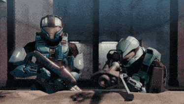 a man in a blue helmet is holding a gun while another man in a green helmet looks on