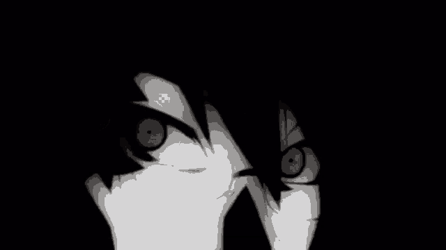 a black and white photo of a person 's face with a large eye in the dark .