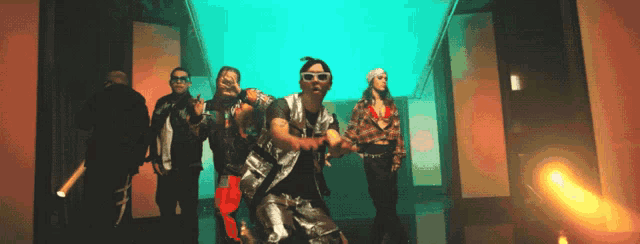 a group of people are dancing in a hallway with a green background