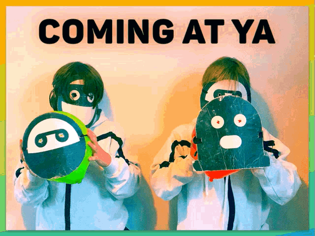 two kids holding masks in front of a sign that says " coming at ya "