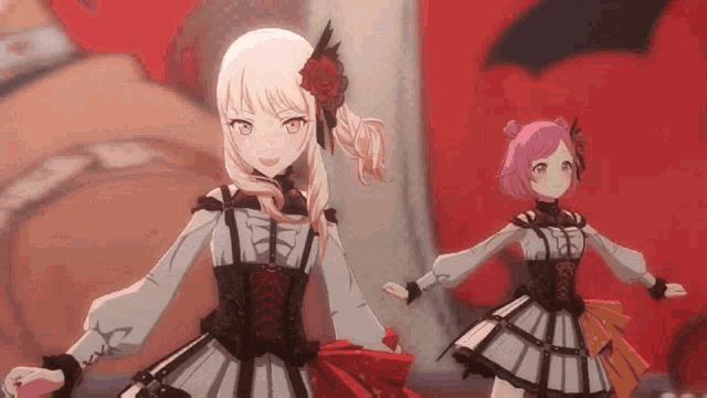 two anime girls are dancing on a stage .