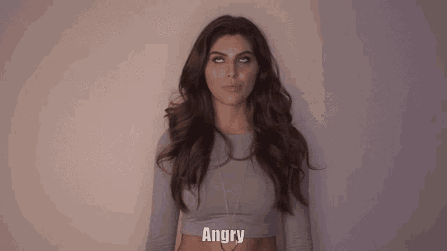 a woman in a gray crop top with the word angry below her