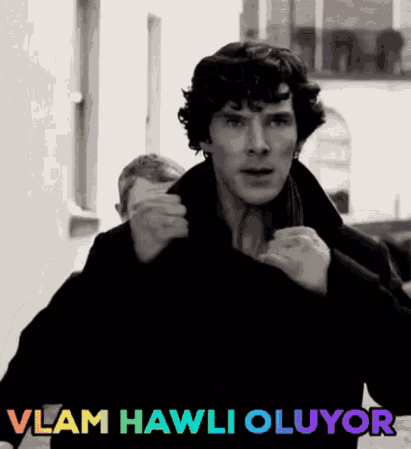 a black and white photo of a man with the words vlam hawli oluyor written on the bottom