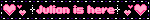a sign that says julian is here with pink hearts on it