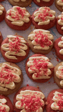 a bunch of cookies with pink frosting and sprinkles on them