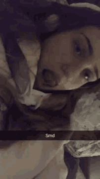 a woman is making a funny face with her tongue out .