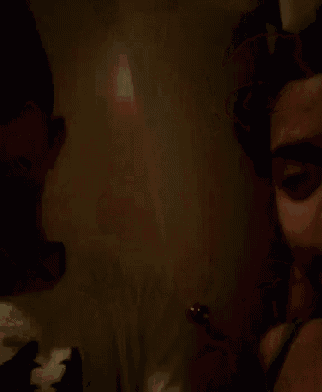 a blurry picture of a man in a white shirt in the dark .