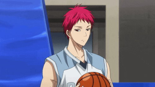 a man with red hair is holding a basketball with the letter r on his jersey