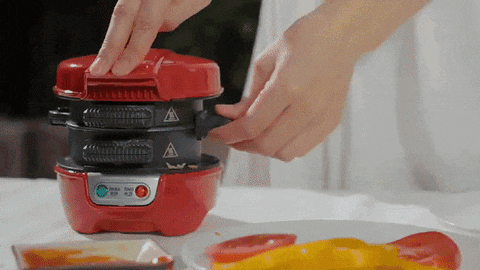 a person is using a machine that has a warning sign on the top