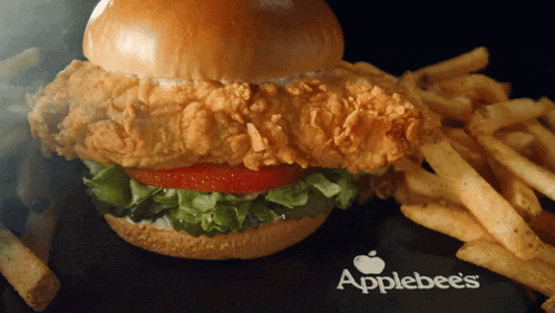 an applebee 's chicken sandwich with french fries on the side