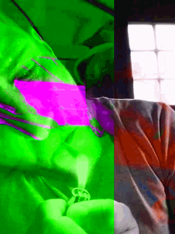 a green and purple image of a person laying down