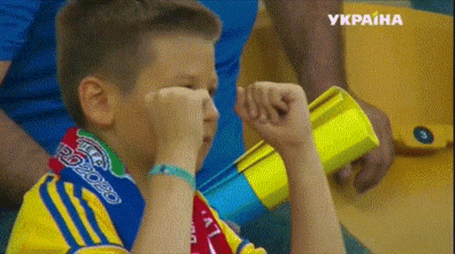 a young boy wearing a scarf that says pd2020