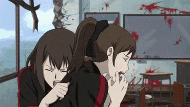 a couple of girls are sitting next to each other in a classroom with blood on the walls