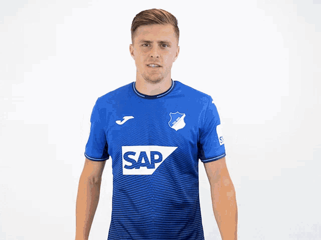 a man wearing a blue shirt with sap on it