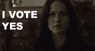 a close up of a woman 's face with the words i vote yes behind her