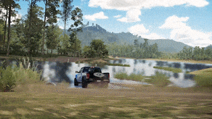 a ford truck is driving through a river