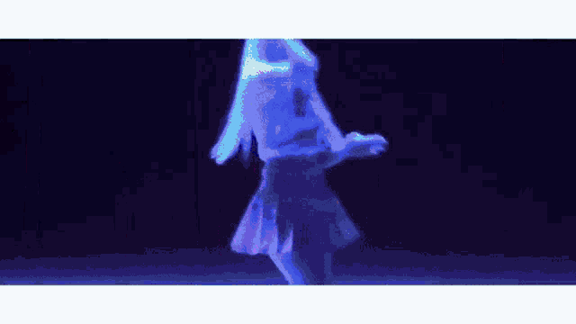 a woman in a purple skirt is dancing in a dark room with a blue light behind her .