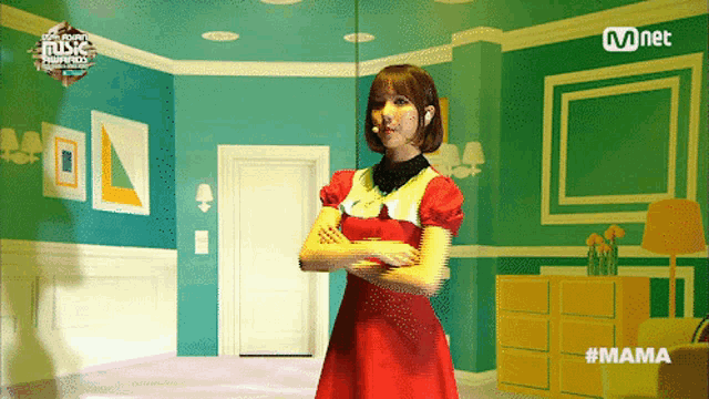 a woman in a red dress is standing in a room with a mnet logo