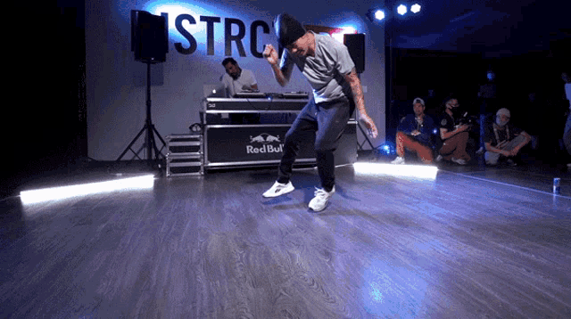 a man dancing in front of a sign that says stro