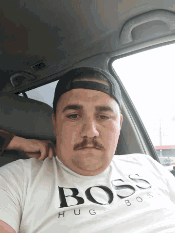 a man wearing a white hugo boss shirt