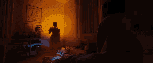 a shadow of a woman is cast on a wall in a room