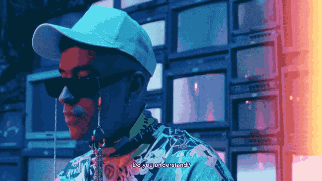 a man wearing sunglasses and a white hat says do you understand