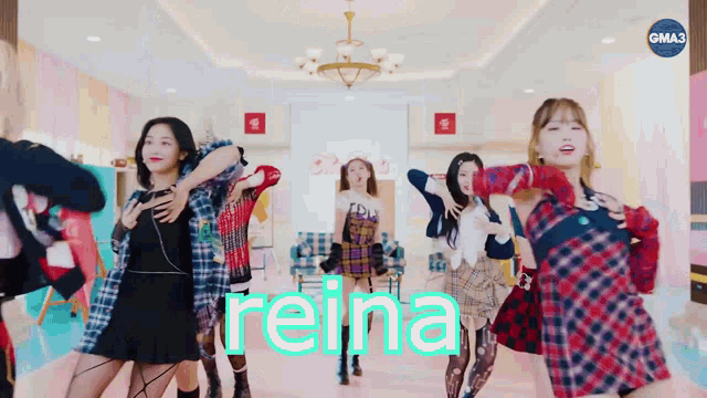 a group of girls are dancing in a room and the word reina is on the screen