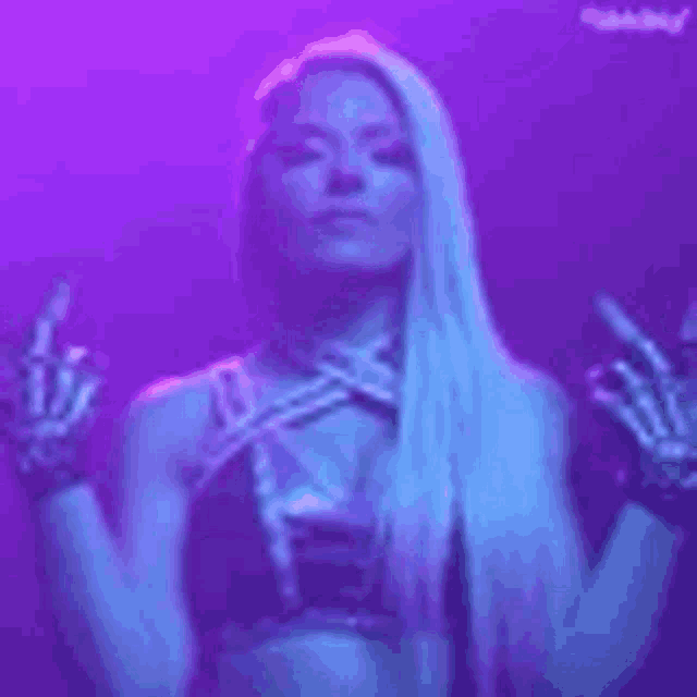 a woman in a bikini and gloves is standing in a dark room with a purple background .
