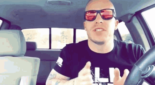 a man wearing sunglasses and a t-shirt that says ll on it