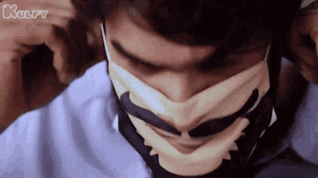 a close up of a man wearing a face mask .