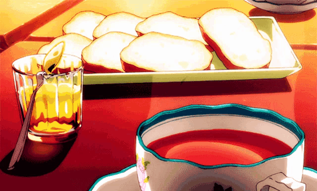 a cup of tea sits on a table next to a tray of sliced bread