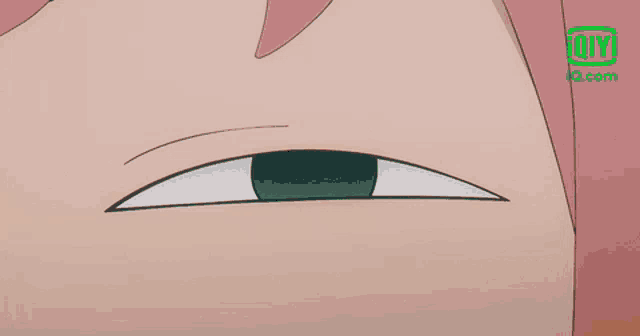 a close up of a cartoon character 's eye with an iq.com logo in the background