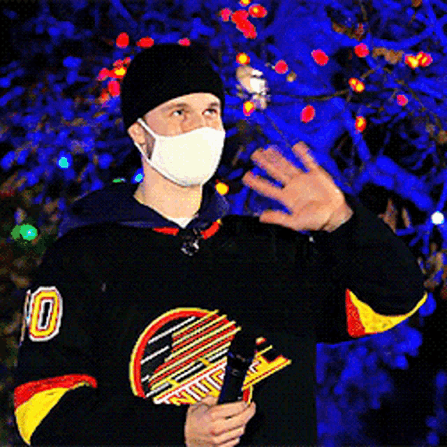 a man wearing a mask and a jersey with the number 10
