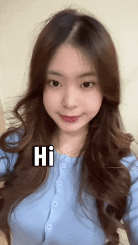 a woman taking a selfie with the word hi written on her face