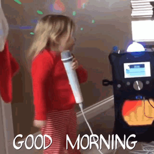 a little girl is singing into a microphone with the words good morning written below her
