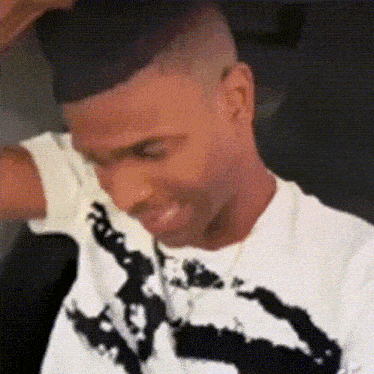 a man wearing a white t-shirt with a black and white graphic on it