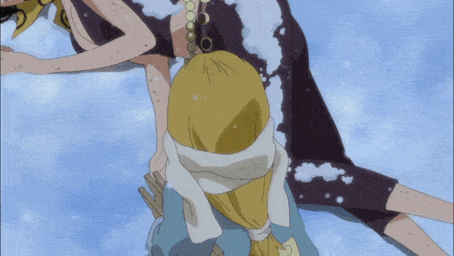 a woman in a black dress is laying on a snowy surface