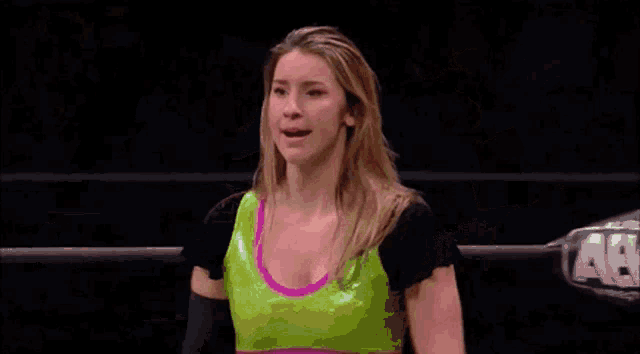 a female wrestler named erica leigh is making a face
