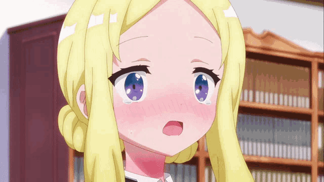 a girl with blonde hair and blue eyes is blushing in front of a bookshelf