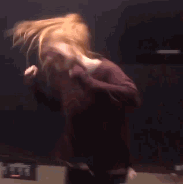 a blurry picture of a woman with her hair blowing in the air