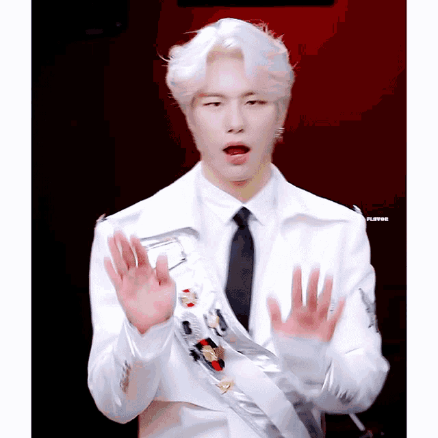 a man in a white suit and tie with the word flavor on the bottom