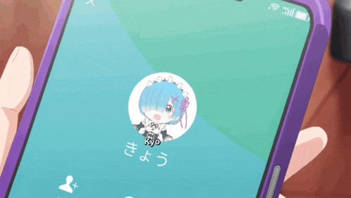 a person is holding a cell phone with a picture of a girl named kyo on the screen