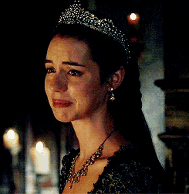 a woman is wearing a tiara and a necklace