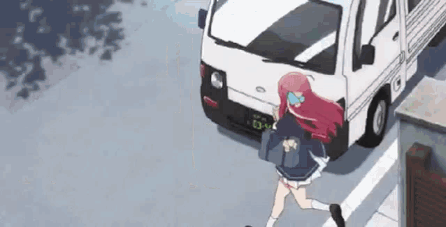 a girl with pink hair is running down the street in front of a truck .