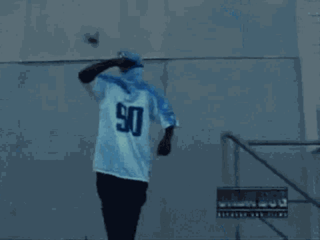 a person wearing a blue and white shirt with the word god written on it