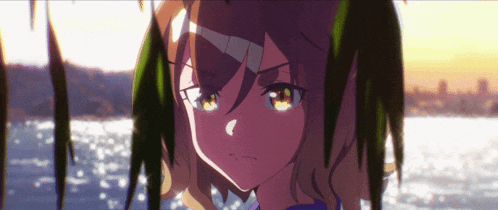 a close up of a girl 's face in front of a body of water with trees in the background